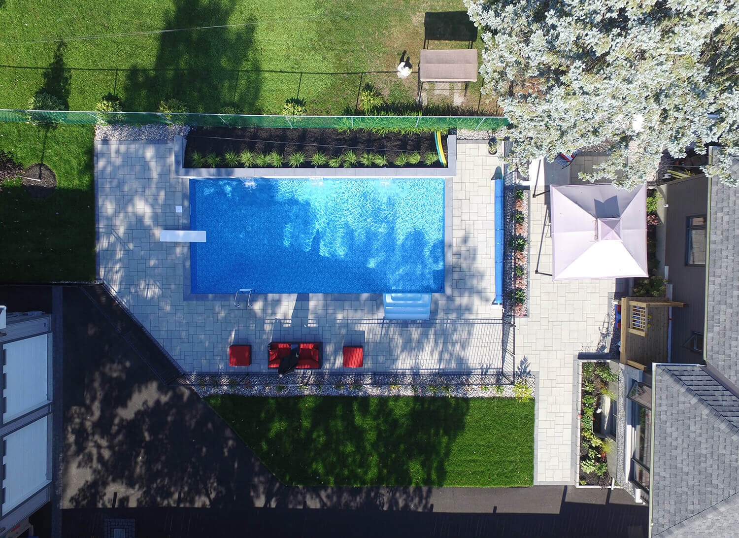 aerial view of backyard oasis with new inground pool and landscaping